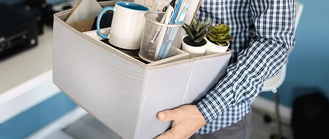 someone carrying a box of desk items