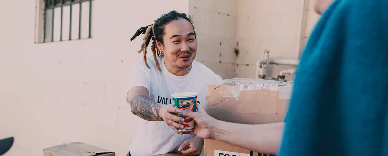 Volunteer handing out a drink at an event
