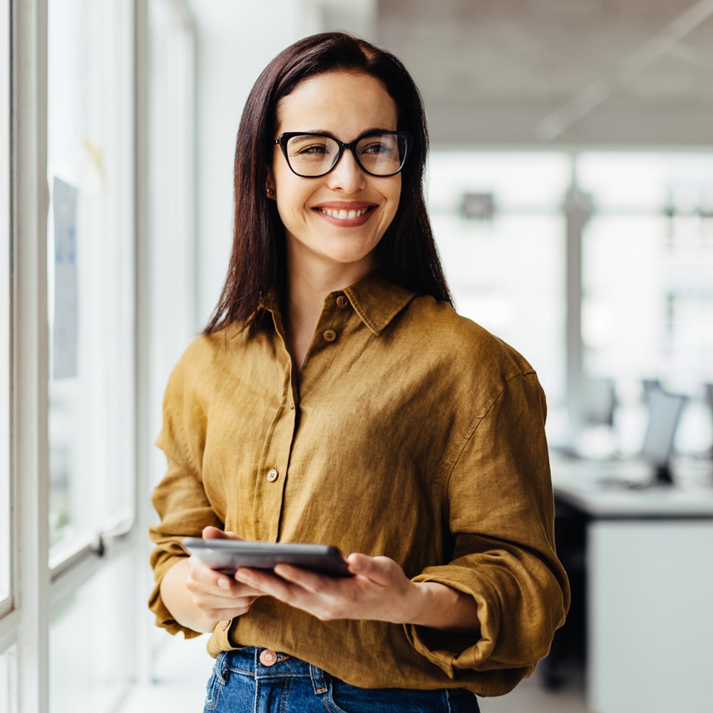 Thoughtful Business Woman Holding A Tablet In An Office