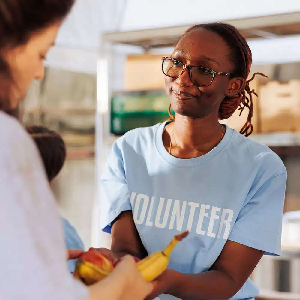 Woman volunteer handing out food at a food pantry