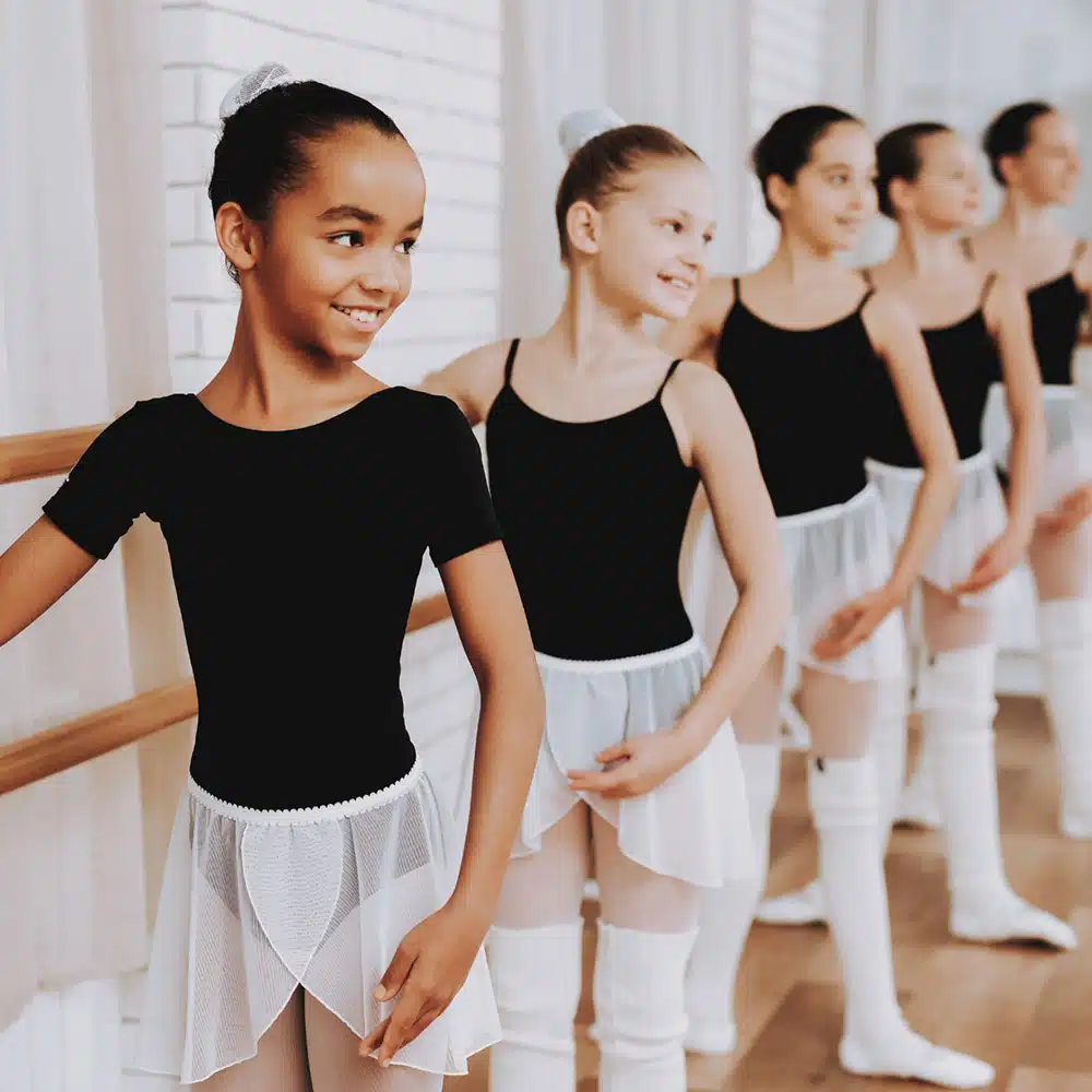 Ballet Training Of Group Of Young Girls Indoors.