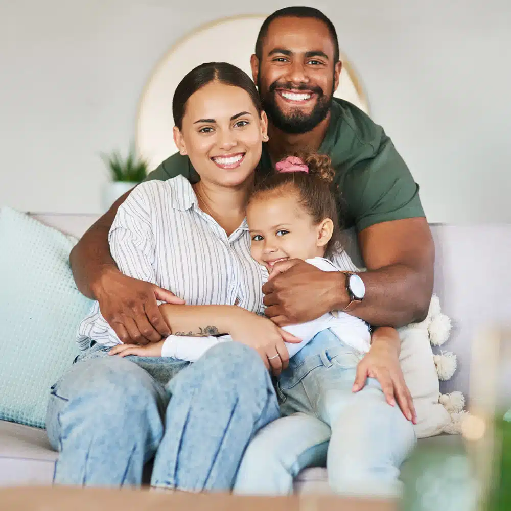 Cuddling Up To A Carefree Day. Portrait Of A Happy Family Relaxing Together At Home.