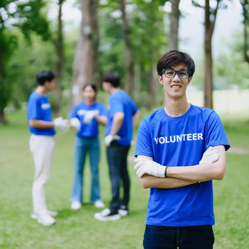 Multiethnic Volunteers Donate Their Time Holding Black Garbage B