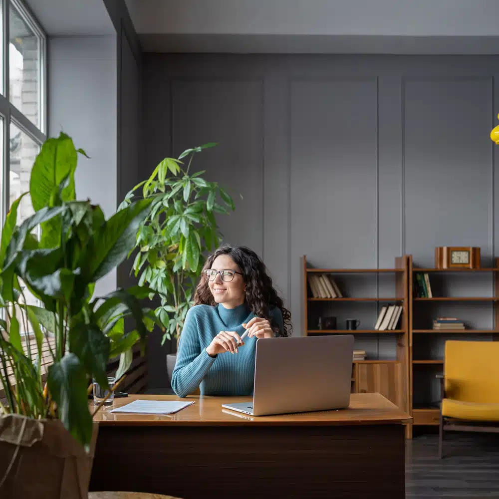Happy Freelancer Female In Coworking Space Look In Window After Successful Video Conference Meeting