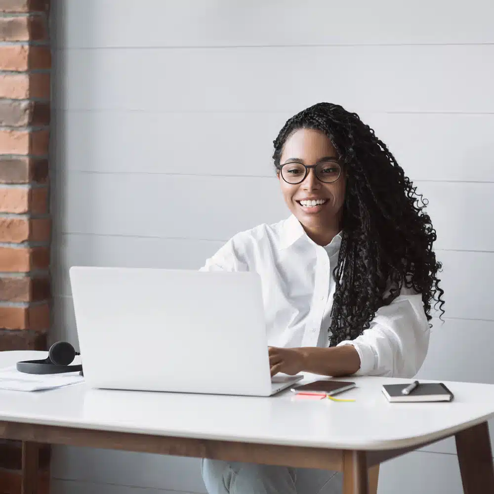 Young Woman Using Laptop Computer At Office. Student Girl Workin