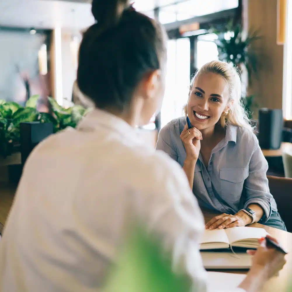 Cheerful Coworkers Talking In Cafe