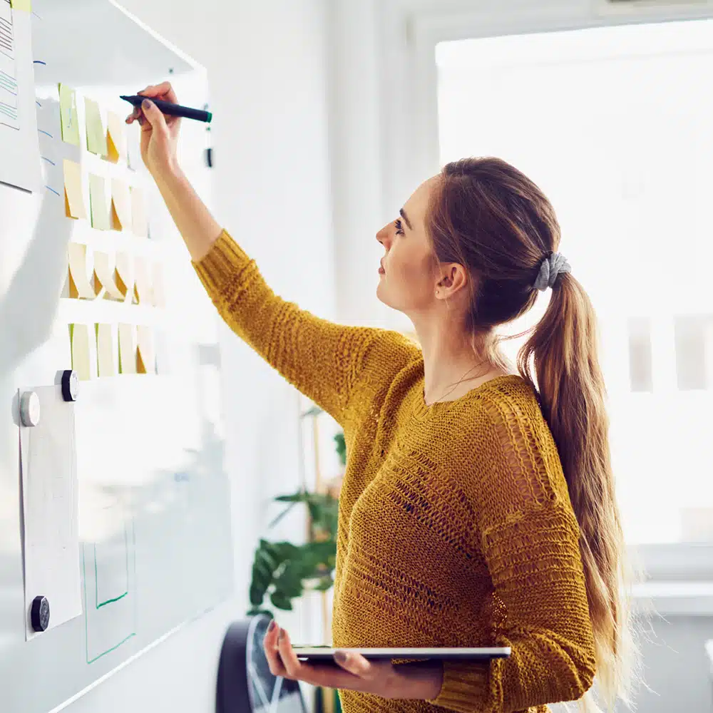Businesswoman Writing On Whiteboard In Office