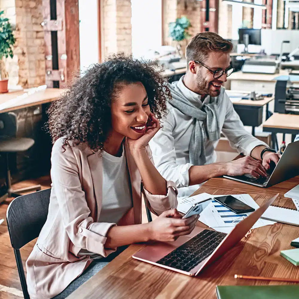 People smiling at desk