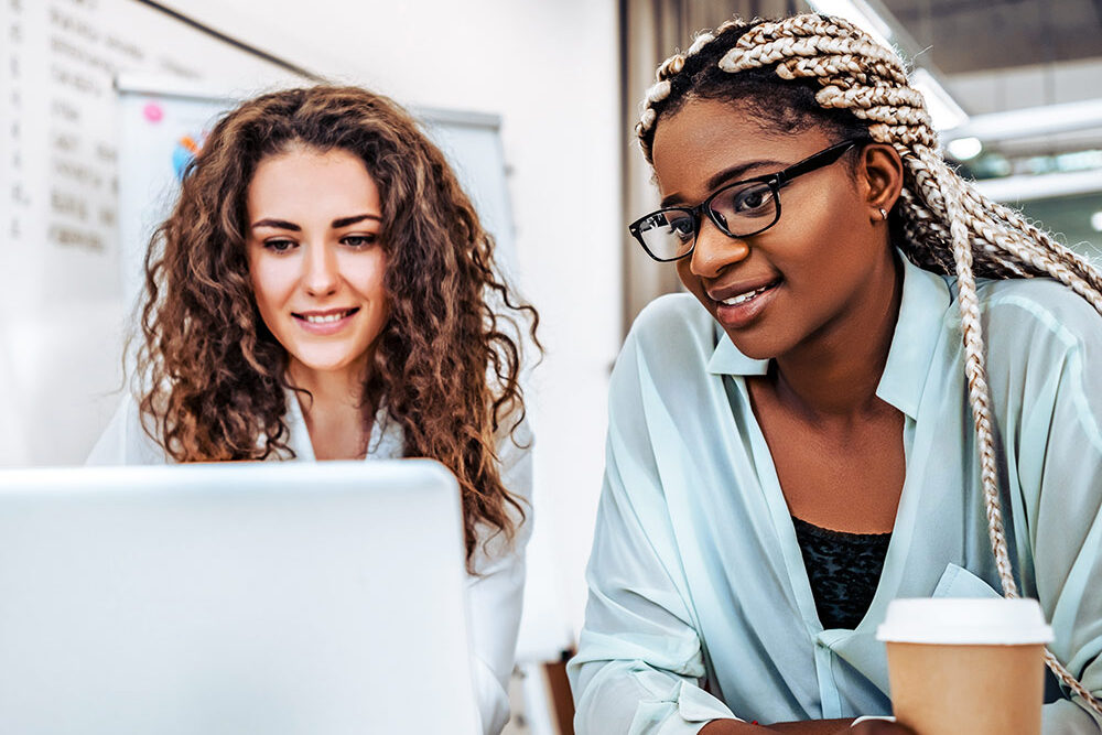 Two Women Happy At Computer