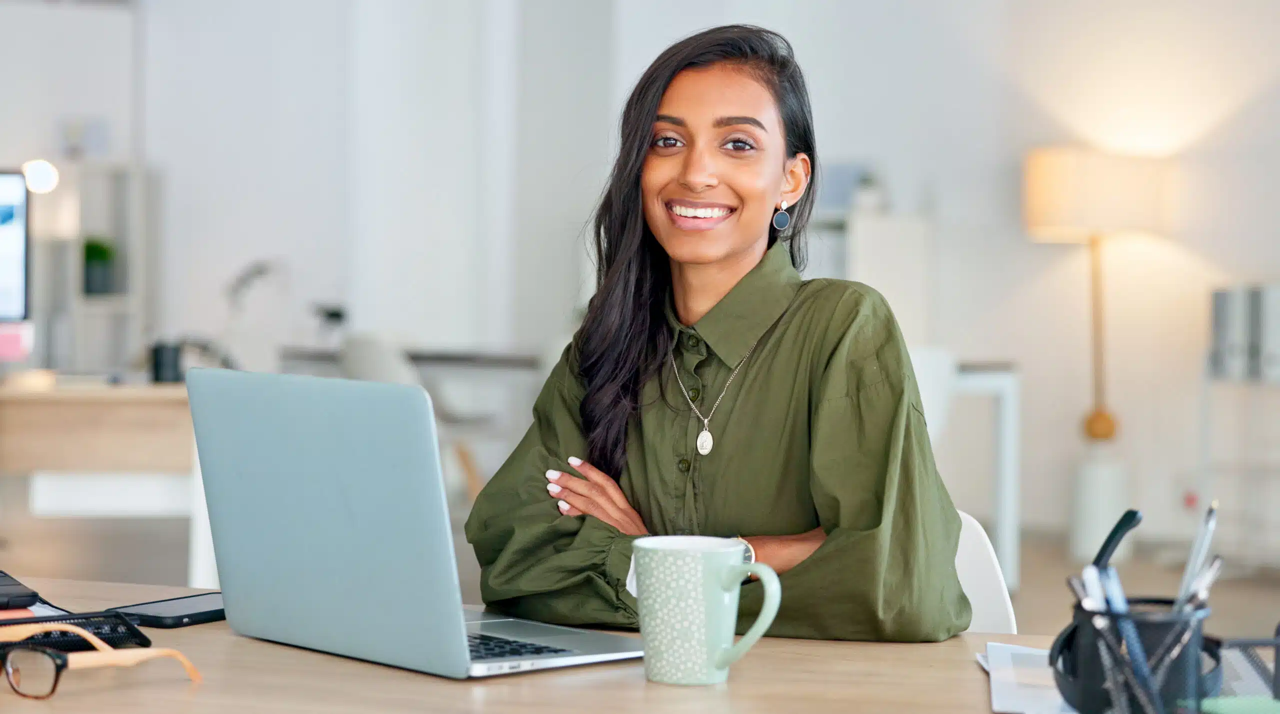 woman working for a nonprofit on her laptop smiling